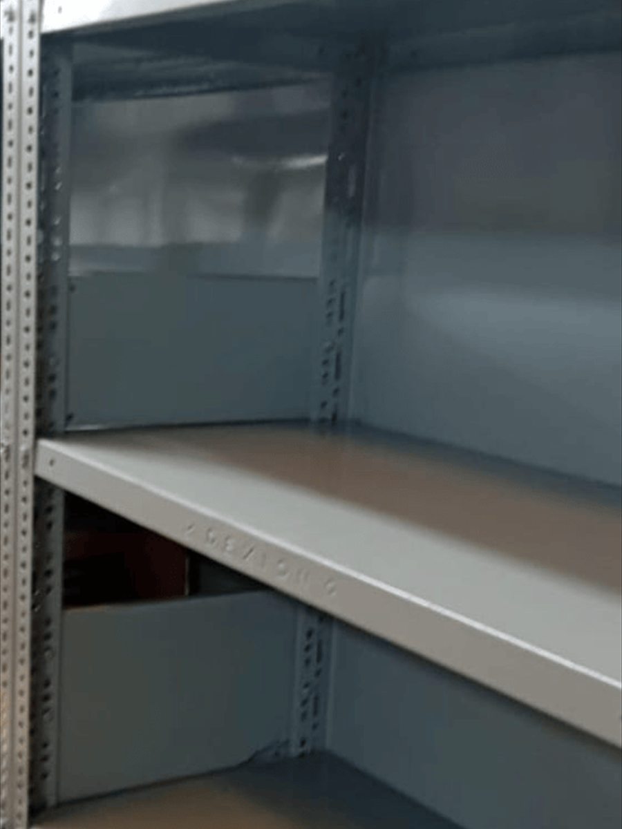 The same shelving after preparation and repainting in uniform grey