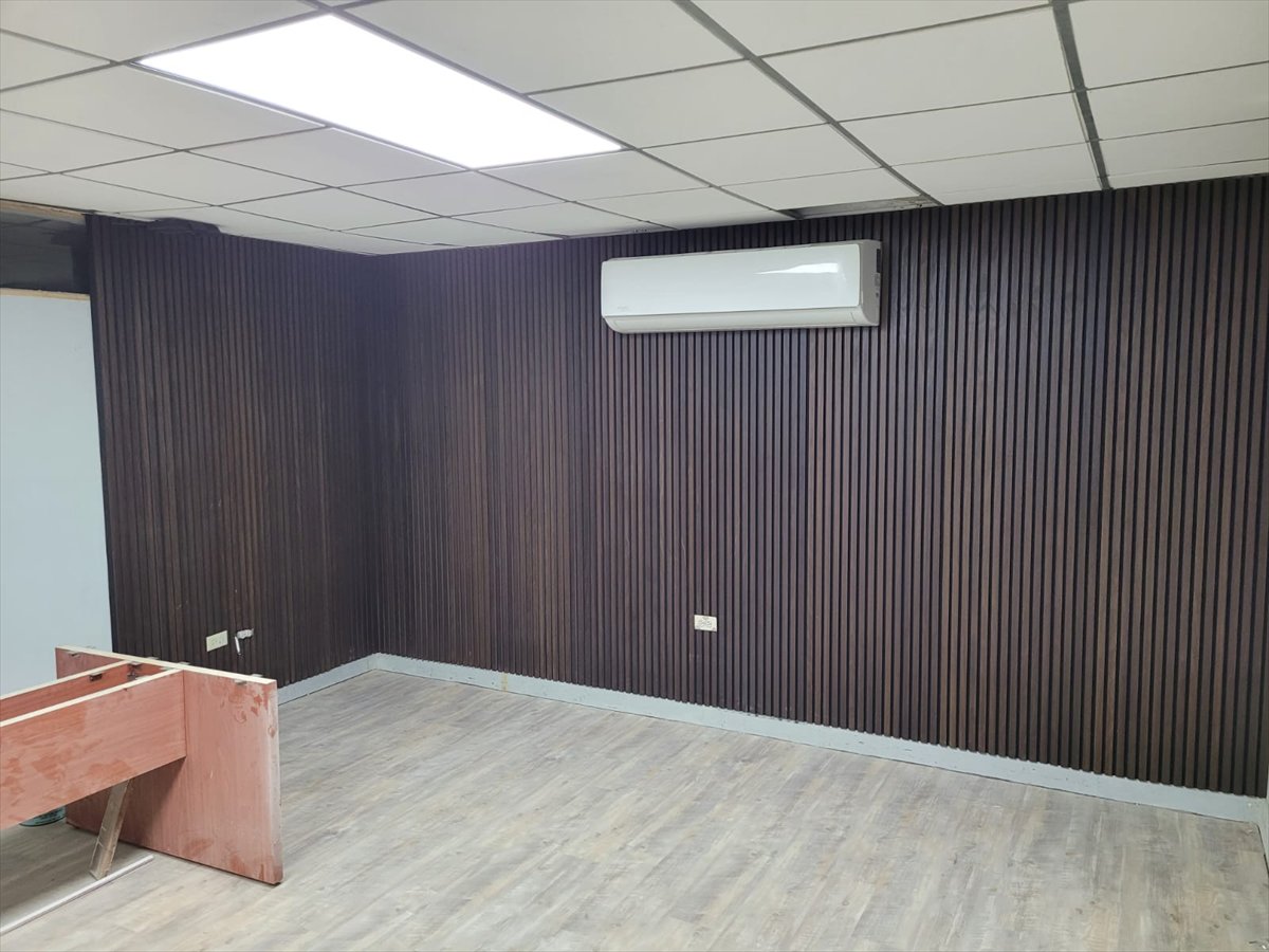 Completed office room with slat wall panelling, suspended ceiling and new flooring