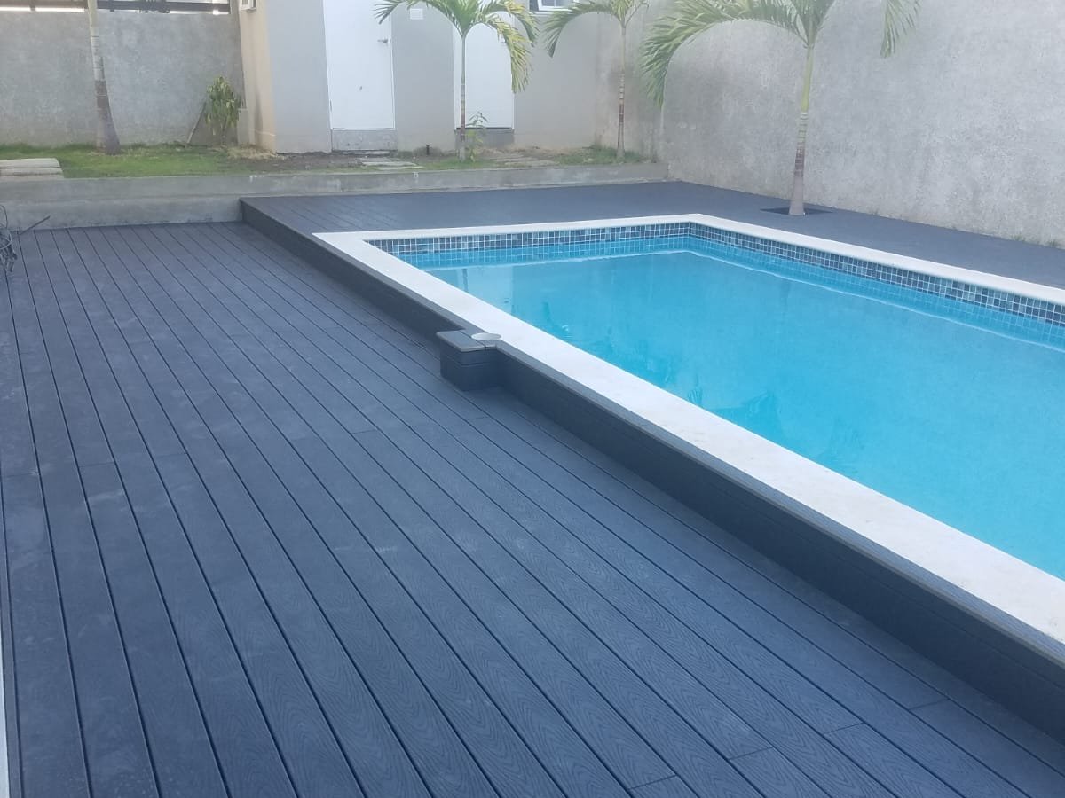 Composite deck boards laid around a swimming pool